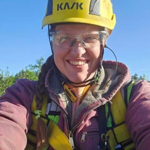Klam firefighter woman in safety gear smiling outdoors, demonstrating women empowerment in skilled trades, construction, and firefighting careers.